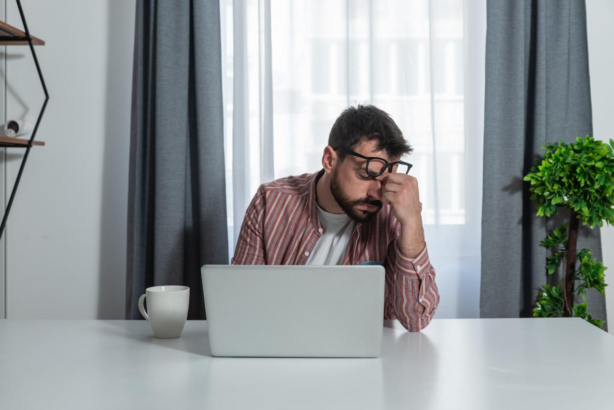 Young freelancer businessman working at home in home office