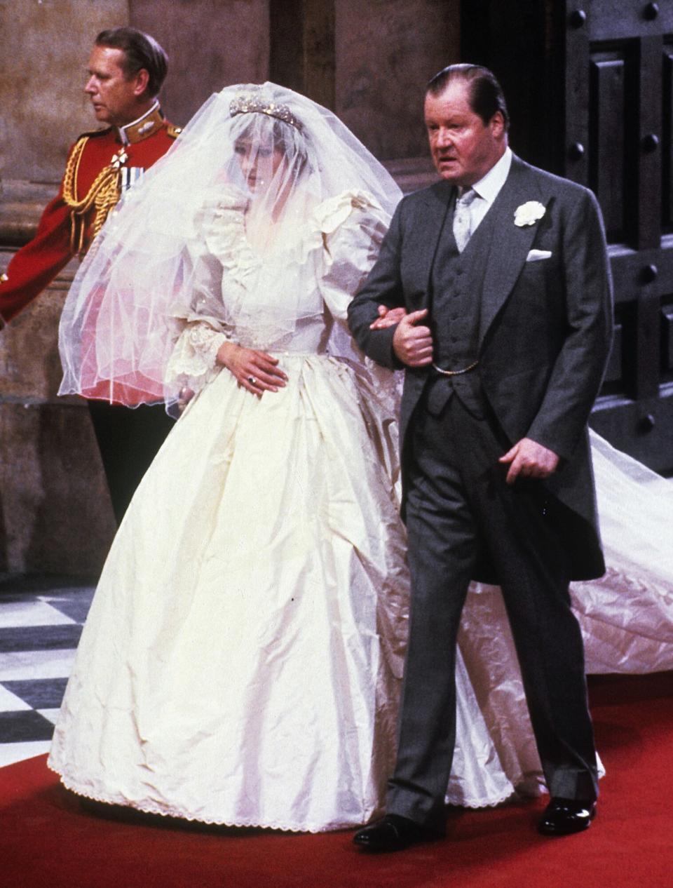 Lady Diana Spencer enters St. Paul's Cathedral on the hand of her father, Earl Spencer, ahead of her marriage to Prince Charles, Prince of Wales on July 29, 1981 in London, England