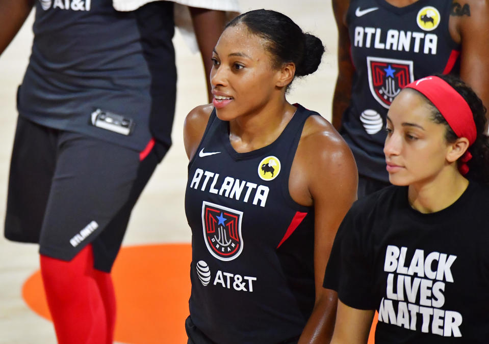 Betnijah Laney of the Atlanta Dream walks off the court next to Jaylyn Agnew after a 97-89 win over the Chicago Sky at Feld Entertainment Center on September 09, 2020 in Palmetto, Florida. / Credit: JULIO AGUILAR / Getty Images
