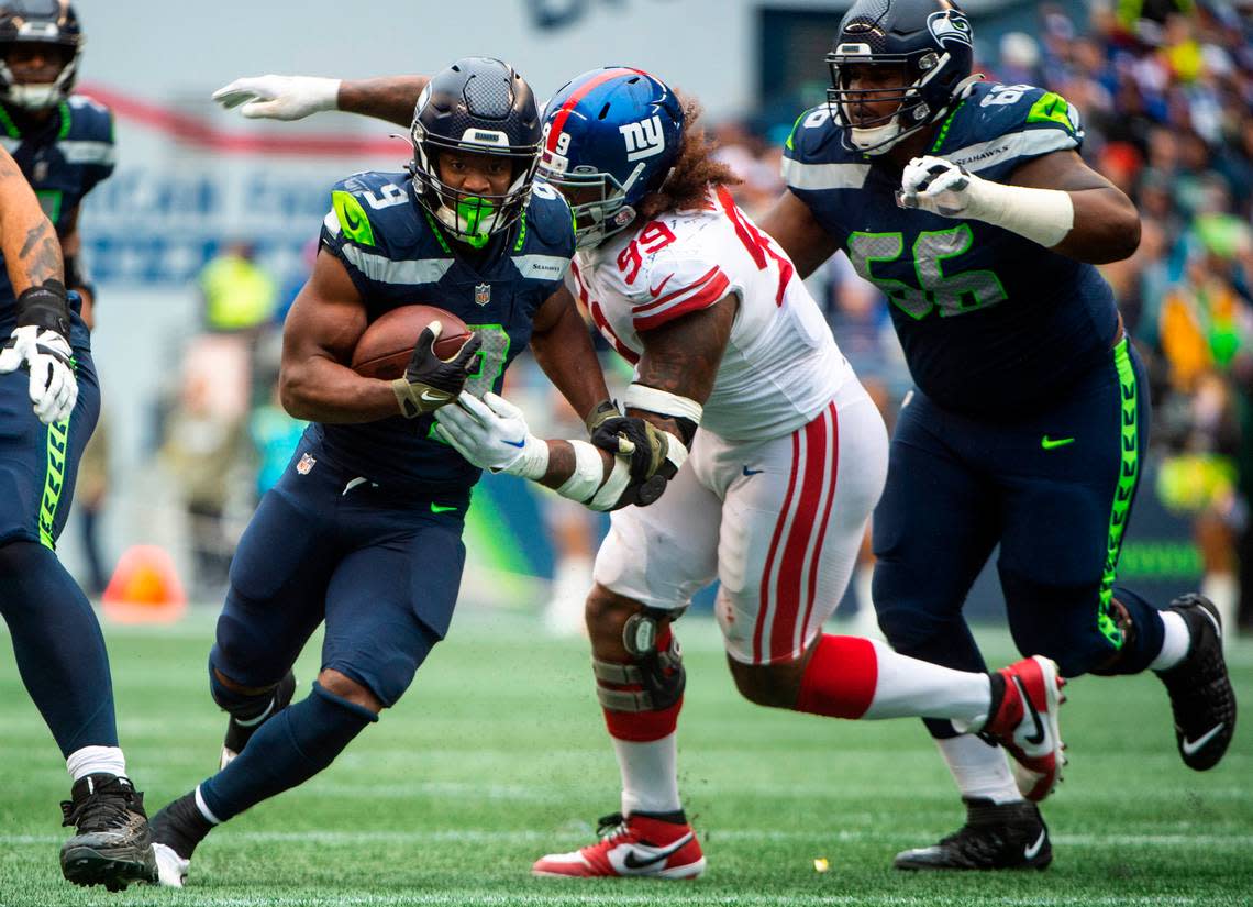 Seattle Seahawks running back Kenneth Walker III (9) runs towards the end zone as New York Giants defensive lineman Leonard Williams (99) tries to tackle him in the second quarter of an NFL game at Lumen Field in Seattle, Wash. on Oct. 30, 2022.