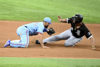 Chicago White Sox's Jose Abreu, right, slides safely into second base in front of a tag by Texas Rangers shortstop Isiah Kiner-Falefa, left, on a force play in the seventh inning of a baseball game in Arlington, Texas, Sunday, Sept. 19, 2021. (AP Photo/Matt Strasen)