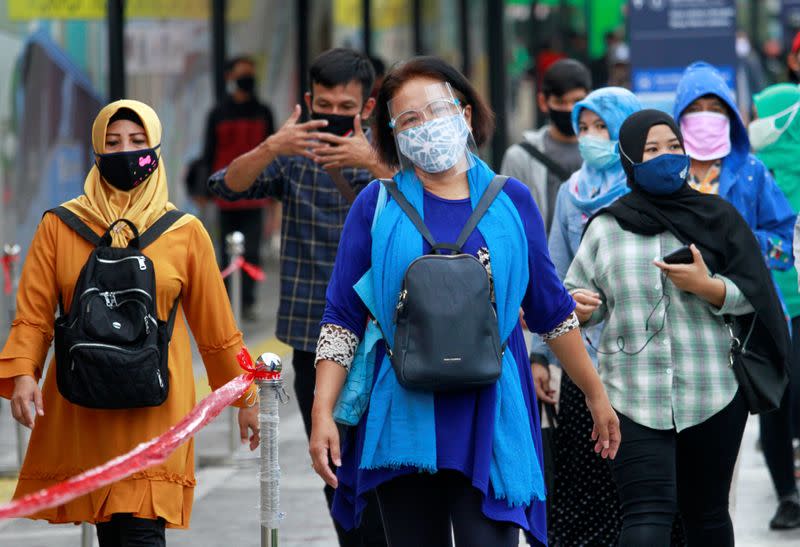 Passengers wear protective face masks at the Tanah Abang Station as Indonesia's capital returns to large-scale social restrictions amid the coronavirus disease (COVID-19) outbreak in Jakarta