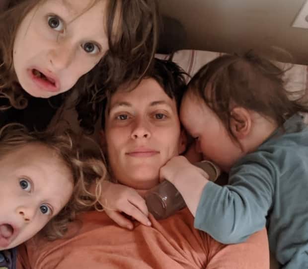 Carina Stone, 37, surrounded by her three children: Dolphin, 8, Hudson, 5 and Ezra, 3. Since her husband died, she finds Mother's Day haunting, not happy, and a reminder of the difficulties she faces as a parent, especially during the pandemic.