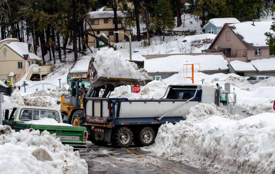 Crews begin removing piles of snow after recent storms dropped more than 100 inches of snow in the San Bernardino Mountains on March 6, 2023 in Crestline, California. / Credit: Gina Ferazzi