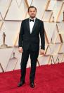 DiCaprio looked polished in a tailored tux as he arrived solo on the Oscars red carpet.