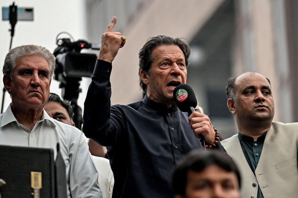 Pakistan's former prime minister Imran Khan (C) addresses his supporters during an anti-government march towards capital Islamabad, demanding early elections, in Gujranwala on November 1, 2022.