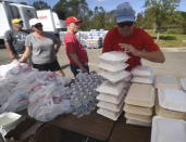 John Davis grabs meals to had out at the NC Baptist Men's relief site at First Baptist Activity Center in Wilmington N.C., Sunday, September 23, 2018. The organization was distributing more than 16,000 meals on Sunday.(Matt Born/The Star-News via AP)