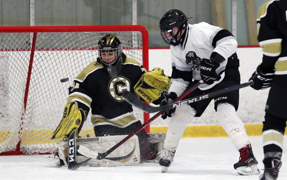 From left, Clarkstown goalie Remy Moreno (31) deflects a shot from the BYSNS's Thomas Eberhardt (8) during hockey action at the Brewster Ice Arena Jan. 15, 2022.