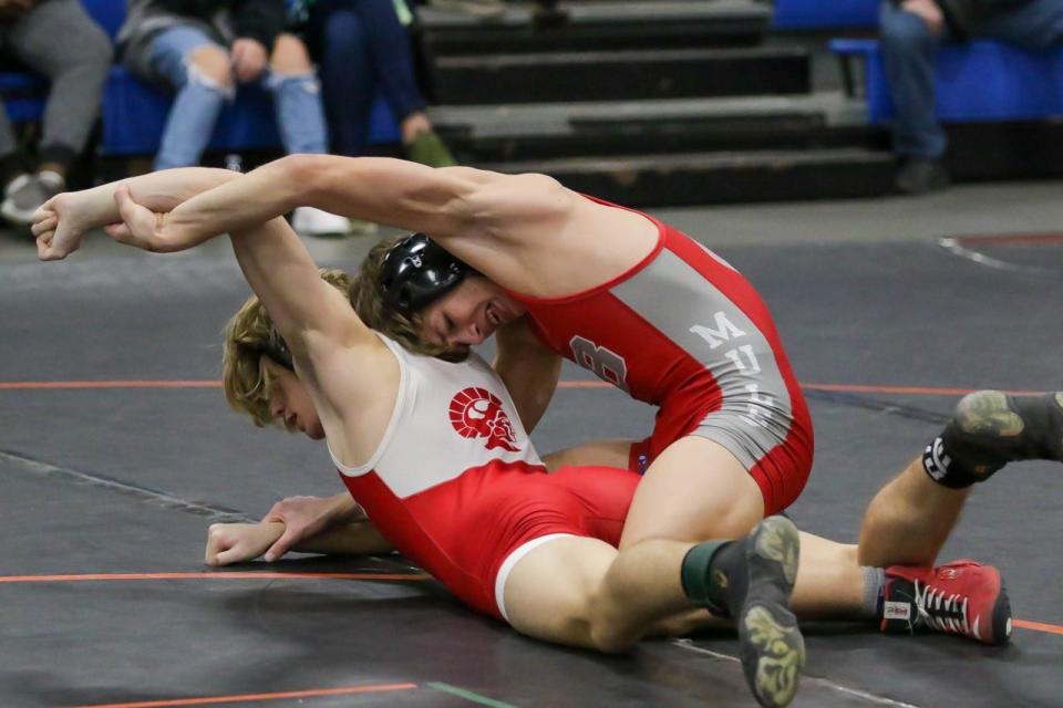 Jack Nigh of Bedford controls Brock Graves of Monroe in the Southeastern Conference finals Saturday.