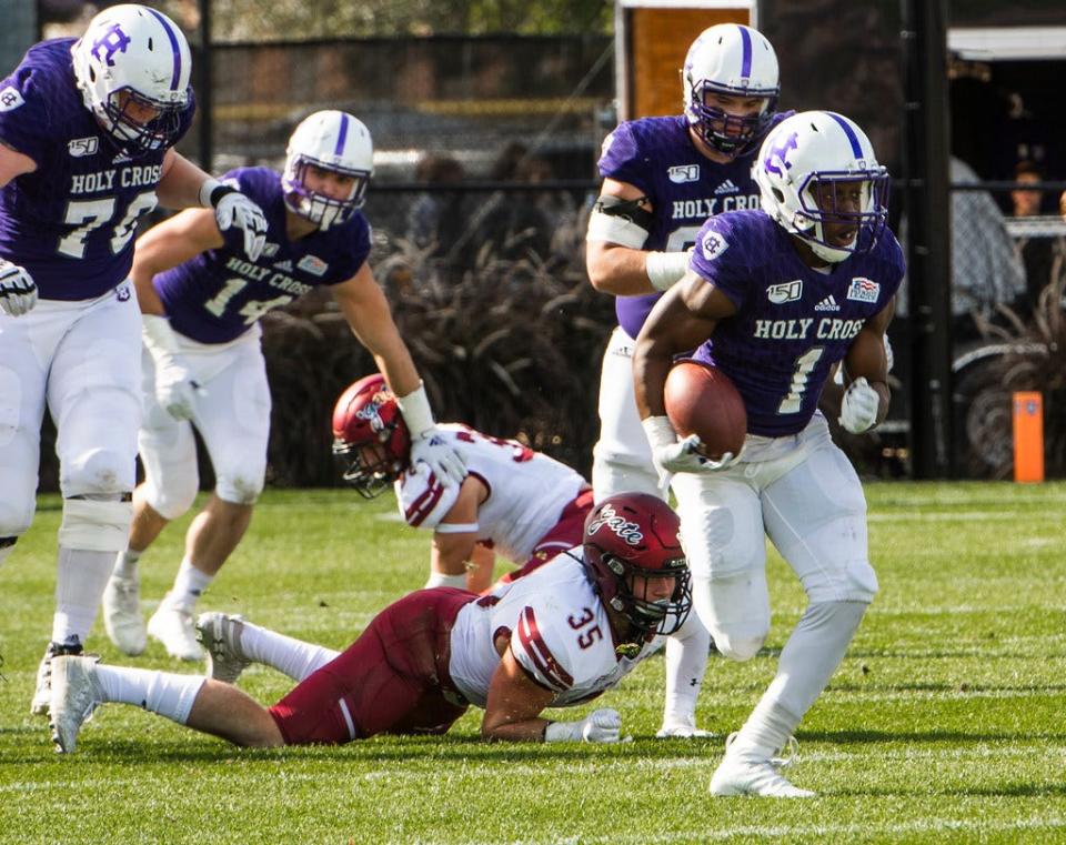 Holy Cross’ running back Domenic Cozier runs the ball during a game against Colgate in 2019.