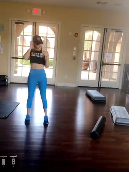 Khloe Kardashian shows off her toned figure in a blue sports bra during an  early morning gym workout