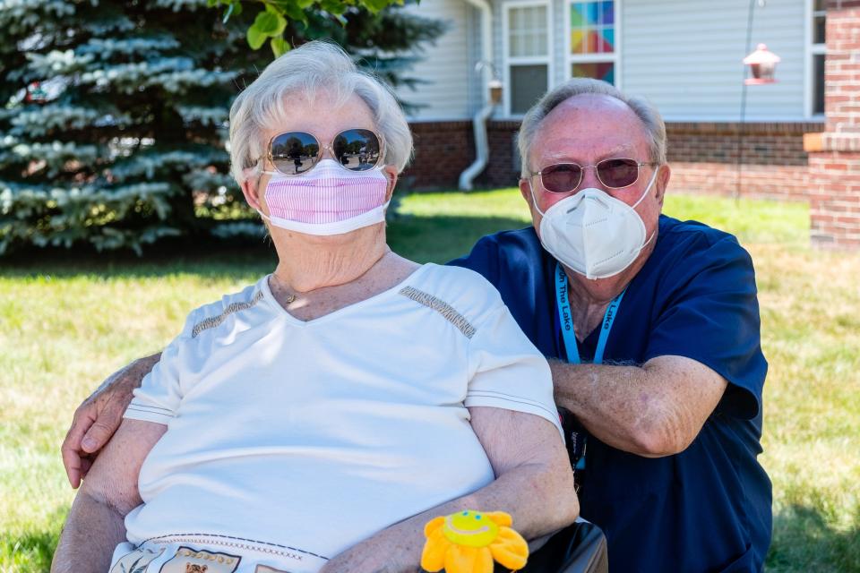 Carol and Larry Burnett hang out on the lawn at Regency-on-the-Lake in Fort Gratiot Friday, July 24, 2020. Larry took a job at the nursing home to be able to see his wife, who is a resident, after the coronavirus pandemic made them stop allowing in-person visits.