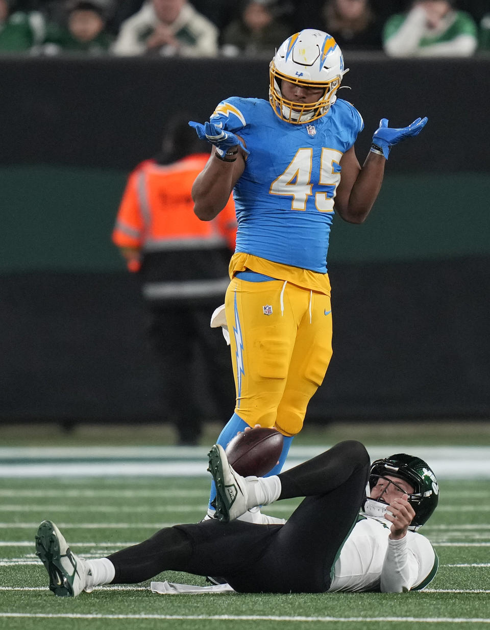 Los Angeles Chargers linebacker Tuli Tuipulotu (45) reacts after sacking New York Jets quarterback Zach Wilson (2) during the second quarter of an NFL football game, Monday, Nov. 6, 2023, in East Rutherford, N.J. (AP Photo/Seth Wenig)