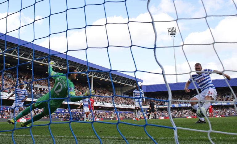 Queens Park Rangers' Richard Dunne (R) scores an own-goal during their English Premier League match against Liverpool at Loftus Road in London on October 19, 2014