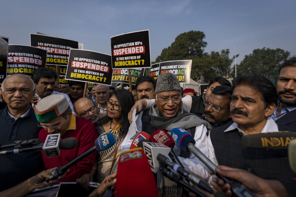 Congress party President Mallikarjun Kharge, third right, addresses the media after suspended lawmakers marched outside the Parliament House in New Delhi, India, Thursday, Dec. 21, 2023. Dozens of opposition lawmakers suspended from Parliament by Prime Minister Narendra Modi's government for obstructing proceedings in the chamber held a street protest on Thursday accusing the government of throttling democracy in the country. (AP Photo/Altaf Qadri)