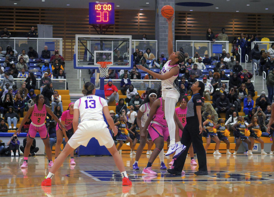 LSU forward Angel Reese tips the ball during an NCAA college basketball game against the Coppin State, Wednesday, Dec. 20, 2023 in Baltimore. (Karl Merton Ferron/The Baltimore Sun via AP)