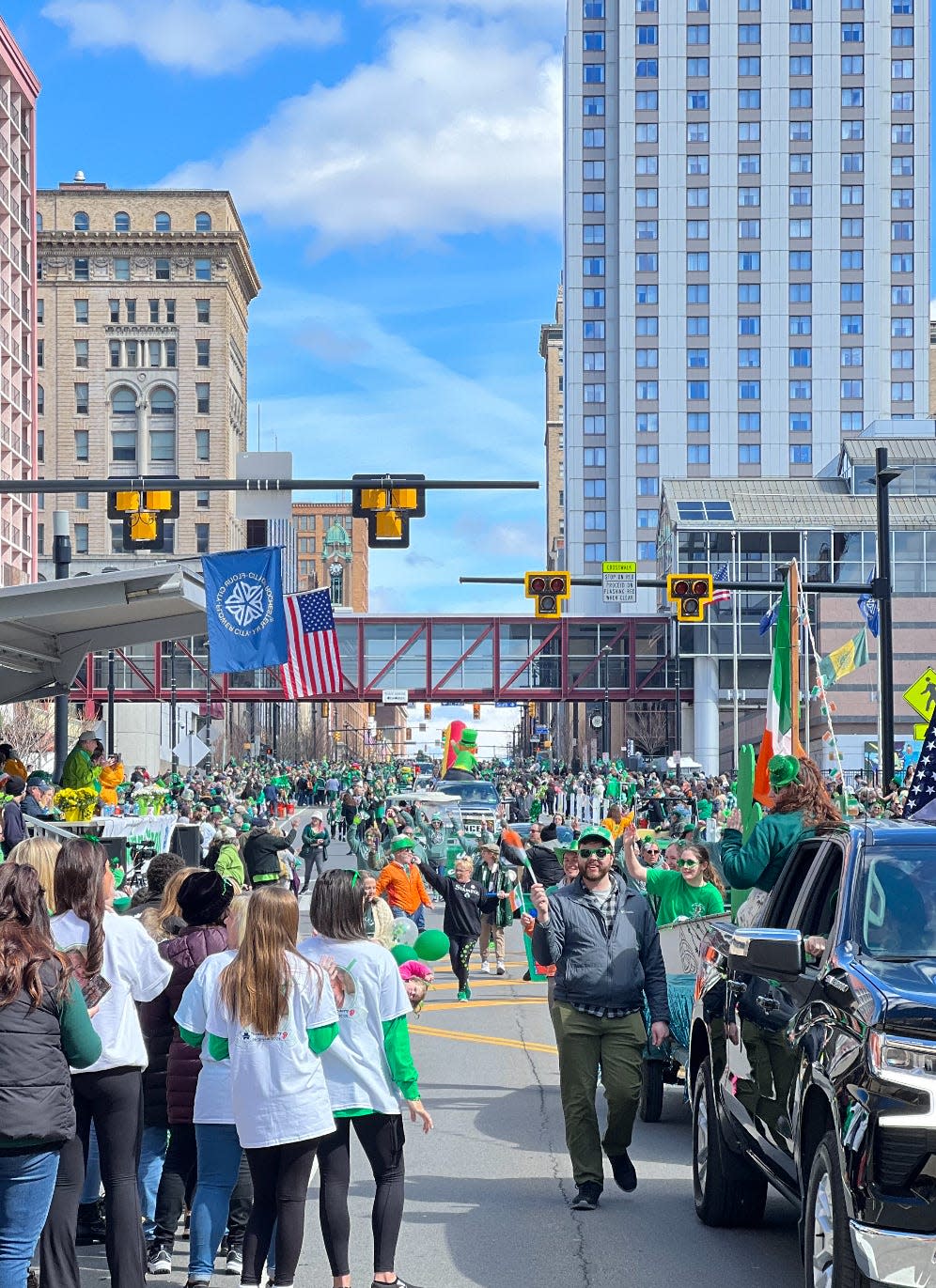 A big crowd cheers as the St. Patrick's Day Parade rolls down Main Street in downtown Rochester on Saturday, March 16, 2024.