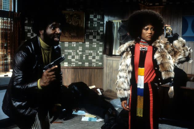 Leonard Thomas holds a gun with Theresa Randle in a scene from the film 