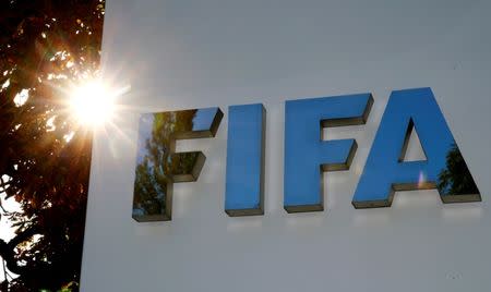 FILE PHOTO: The logo of FIFA is seen in front of its headquarters in Zurich, Switzerland September 26, 2017. REUTERS/Arnd Wiegmann