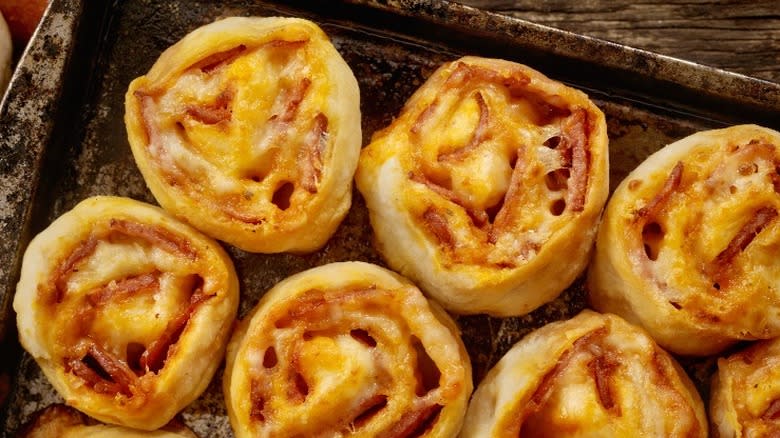 Top-down view of cooked pizza rolls on a pan