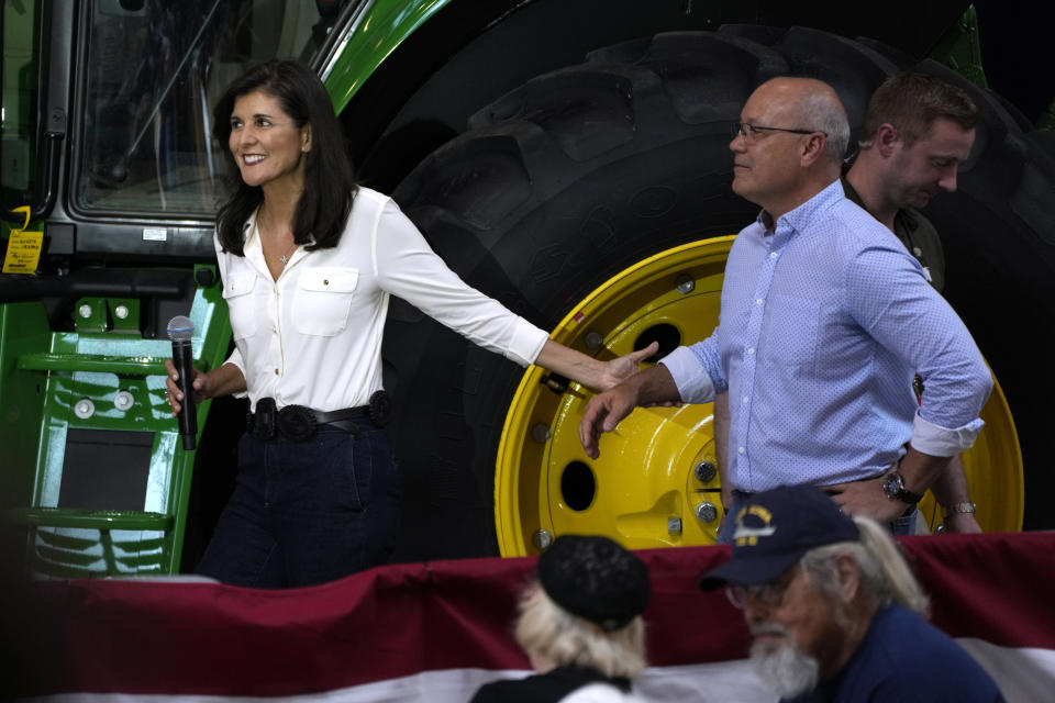 Republican presidential candidate and former U.N. Ambassador Nikki Haley walks to the stage with her husband Michael during U.S. Sen. Joni Ernst's Roast and Ride, Saturday, June 3, 2023, in Des Moines, Iowa. (AP Photo/Charlie Neibergall)