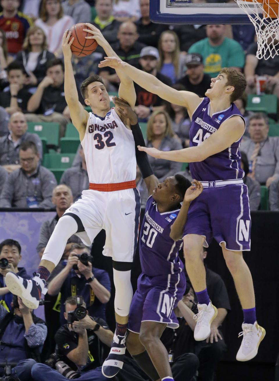 <p>Northwestern’s Gavin Skelly (44) and Scottie Lindsey (20) defend against Gonzaga forward Zach Collins (32) during the first half of a second-round college basketball game in the men’s NCAA Tournament, Saturday, March 18, 2017, in Salt Lake City. (AP Photo/Rick Bowmer) </p>