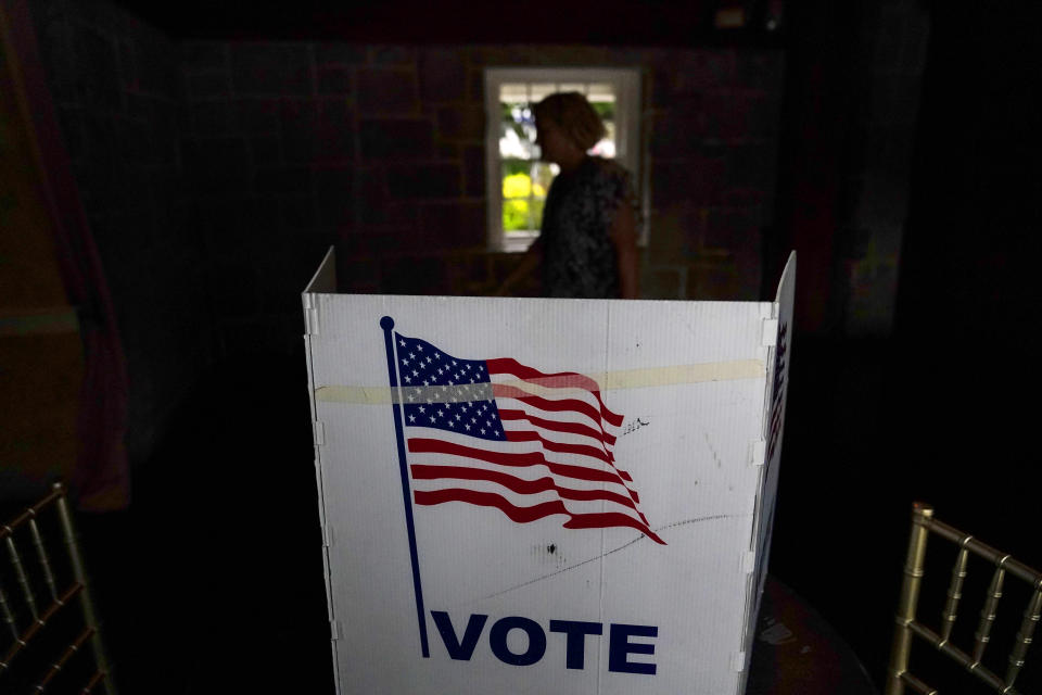 A person waits in line to vote in the Georgia's primary election on Tuesday, May 24, 2022, in Atlanta. (AP Photo/Brynn Anderson)