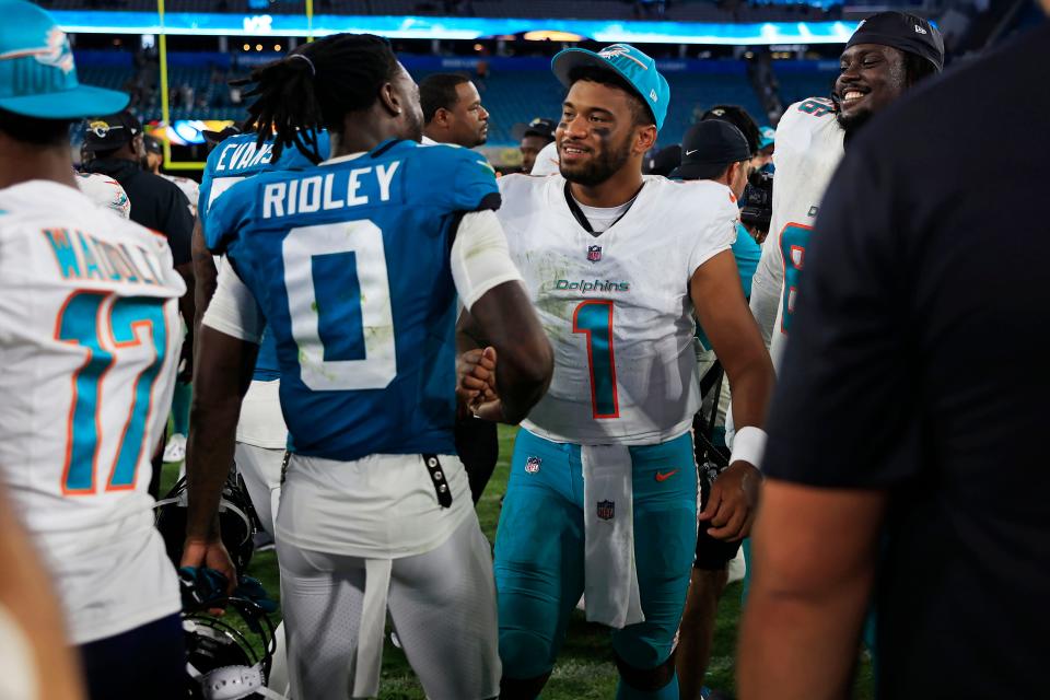 Miami Dolphins quarterback Tua Tagovailoa (1) greets Jacksonville Jaguars wide receiver Calvin Ridley (0) after the game of a preseason matchup Saturday, Aug. 26, 2023 at EverBank Stadium in Jacksonville, Fla. The game was suspended in the fourth after Miami Dolphins wide receiver Daewood Davis (87) was injured on a play with a final score of 31-18.