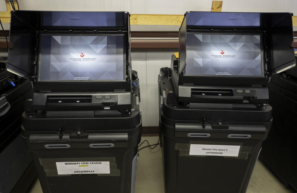 FILE - Dominion Voting ballot-counting machines are shown at a Torrance County warehouse during election equipment testing with local candidates and partisan officers in Estancia, N.M., Sept. 29, 2022. Documents in defamation lawsuit illustrate pressures faced by Fox News journalists in the weeks after the 2020 presidential election. The network was on a collision course between giving its conservative audience what it wanted and reporting uncomfortable truths about then-President Donald Trump and his false fraud claims.(AP Photo/Andres Leighton, File)