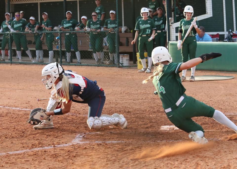 Stetson's Kami Eppley (4) slides into home plate for a run against Florida Atlantic, Tuesday, March 26, 2024, at Patricia Wilson Field.
