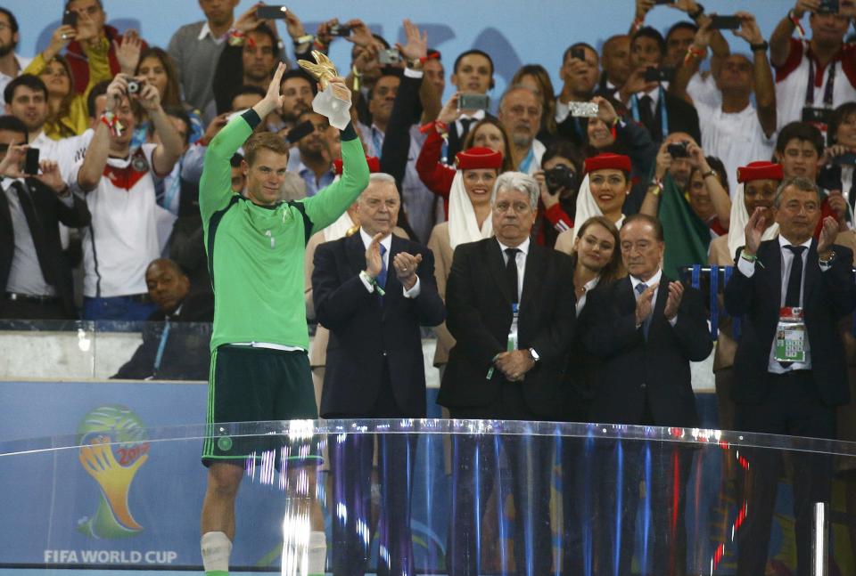 Germany's goalkeeper Neuer holds the Golden Glove trophy after winning their 2014 World Cup final against Argentina at the Maracana stadium in Rio de Janeiro