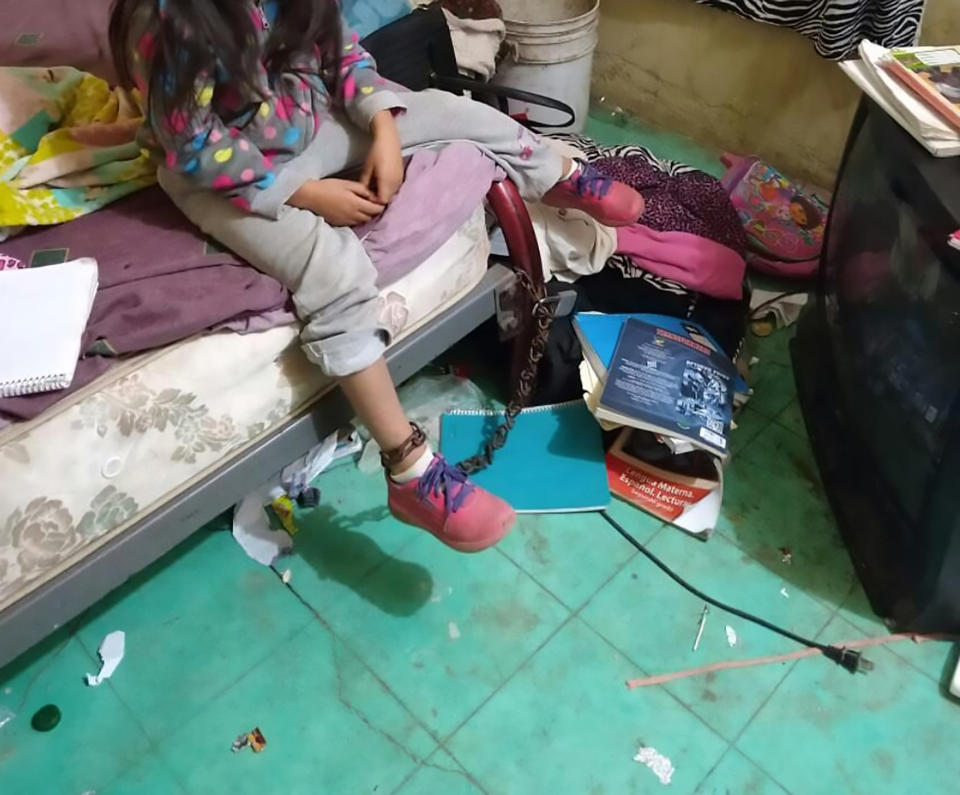 A five-year-old Mexican girl is seen here chained to a bed after neighbours heard screams believed to be from her.