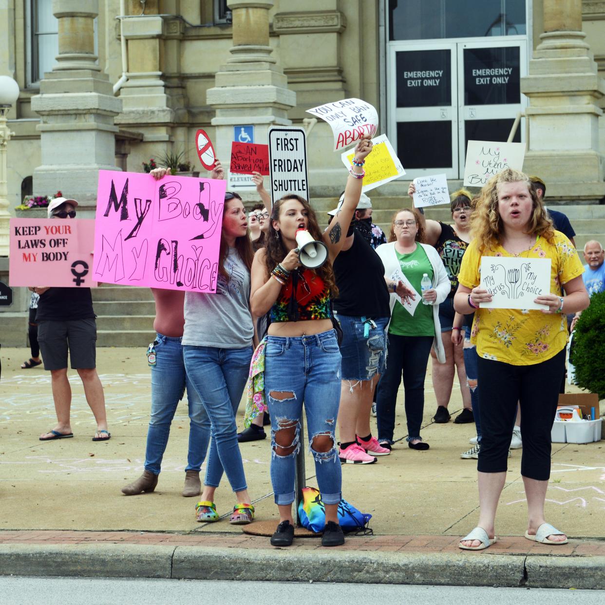 Organizer Darra Durst talks through a megaphone during a protest against the U.S. Supreme Court's overturn of Roe vs. Wade on Wednesday in front of the Muskingum County Courthouse in Zanesville. An event posting through social media website Facebook attracted dozens of activists.