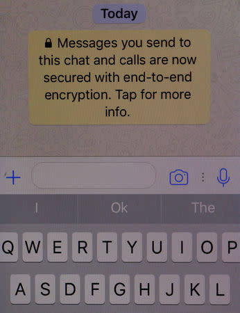 An encryption message is seen on the WhatsApp application on an iPhone in Manchester , Britain March 27, 2017. REUTERS/Phil Noble