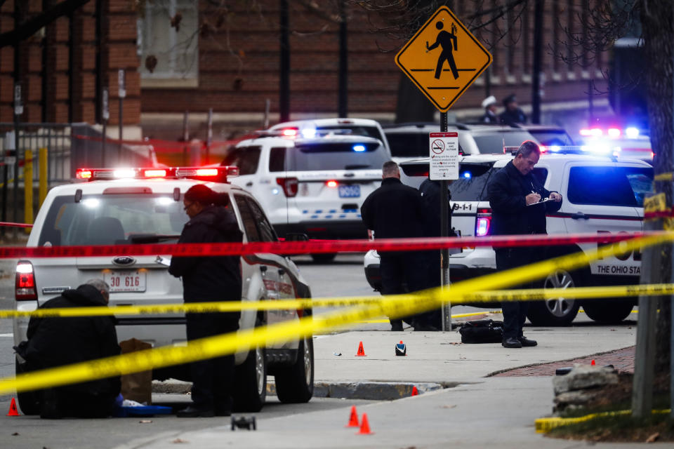 FILE - In this Nov. 28, 2016, file photo, crime scene investigators collect evidence from the pavement as police respond to an attack on the Ohio State University campus in Columbus, Ohio. Ohio State University is beefing up its emergency alert system and streamlining the way officials communicate in a crisis after a November car-and-knife attack exposed some flaws in the text-message procedure. (AP Photo/John Minchillo, File)