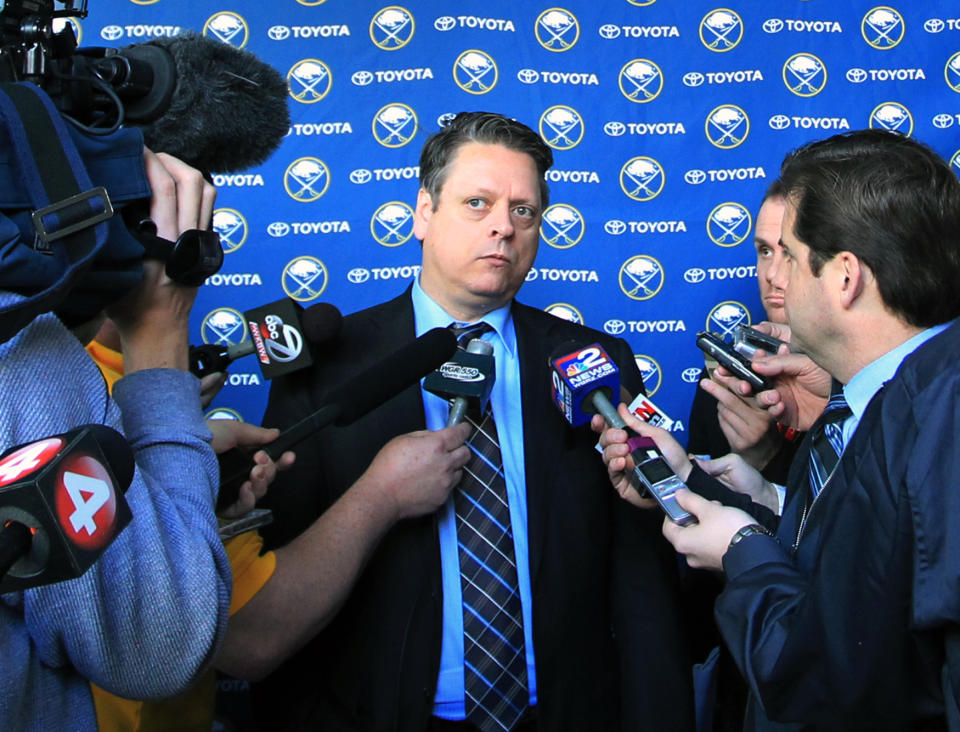 Tim Murray, center, the new Buffalo Sabres hockey team general manager, takes questions from the media at the First Niagara Center in Buffalo, N.Y. , Thursday, Jan. 9, 2014. (AP Photo/Nick LoVerde)