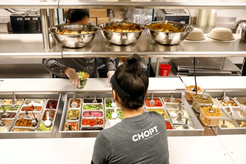 Workers prepare orders in the kitchen at the newest Chopt Creative Salad Co., location in New York