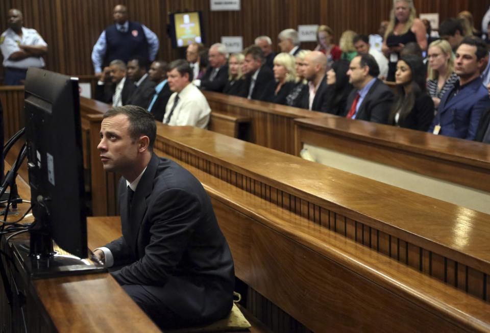 Oscar Pistorius sits in court ahead of his trial at the North Gauteng High Court in Pretoria March 3, 2014. "Blade Runner" Pistorius arrived at the Pretoria High Court on Monday for the start of his murder trial, opening a decisive chapter in the story of the rise and fall of one of the world's best-known athletes. REUTERS/Themba Hadebe/Pool (SOUTH AFRICA - Tags: SPORT ATHLETICS CRIME LAW)