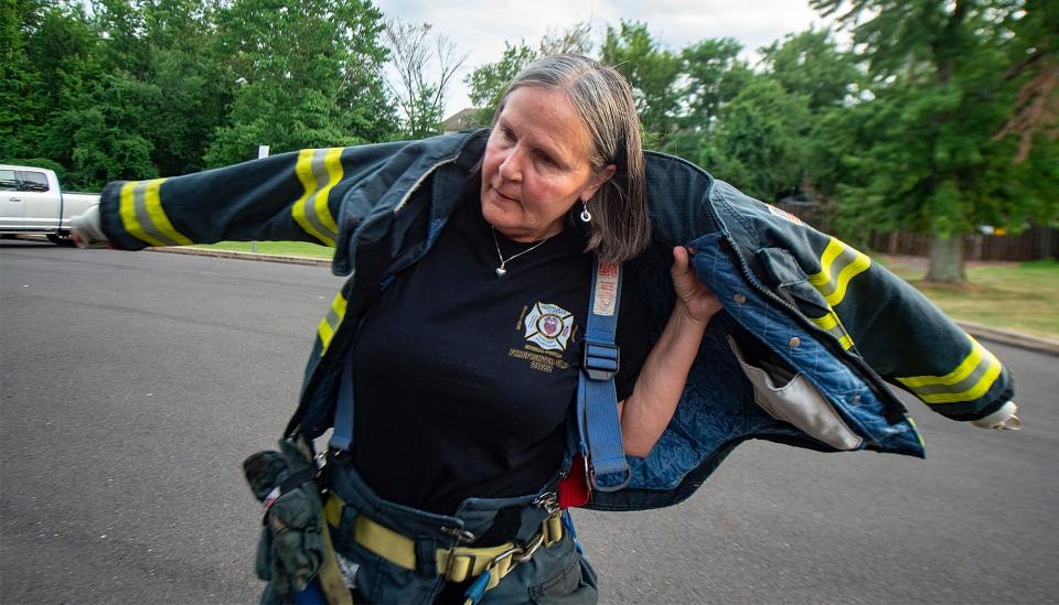 Lynn Kirkner, 57, a firefighter with the Hartsville Fire Company, in Warminster, on Wednesday, July 27, 2022, suits up.