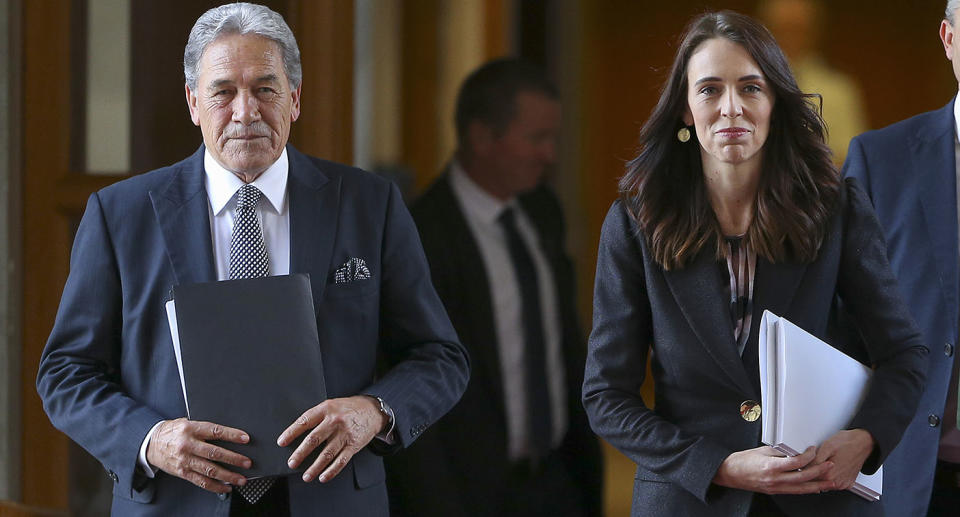 New Zealand Prime Minister Jacinda Ardern, right, walks with Deputy Prime Minister Winston Peters.