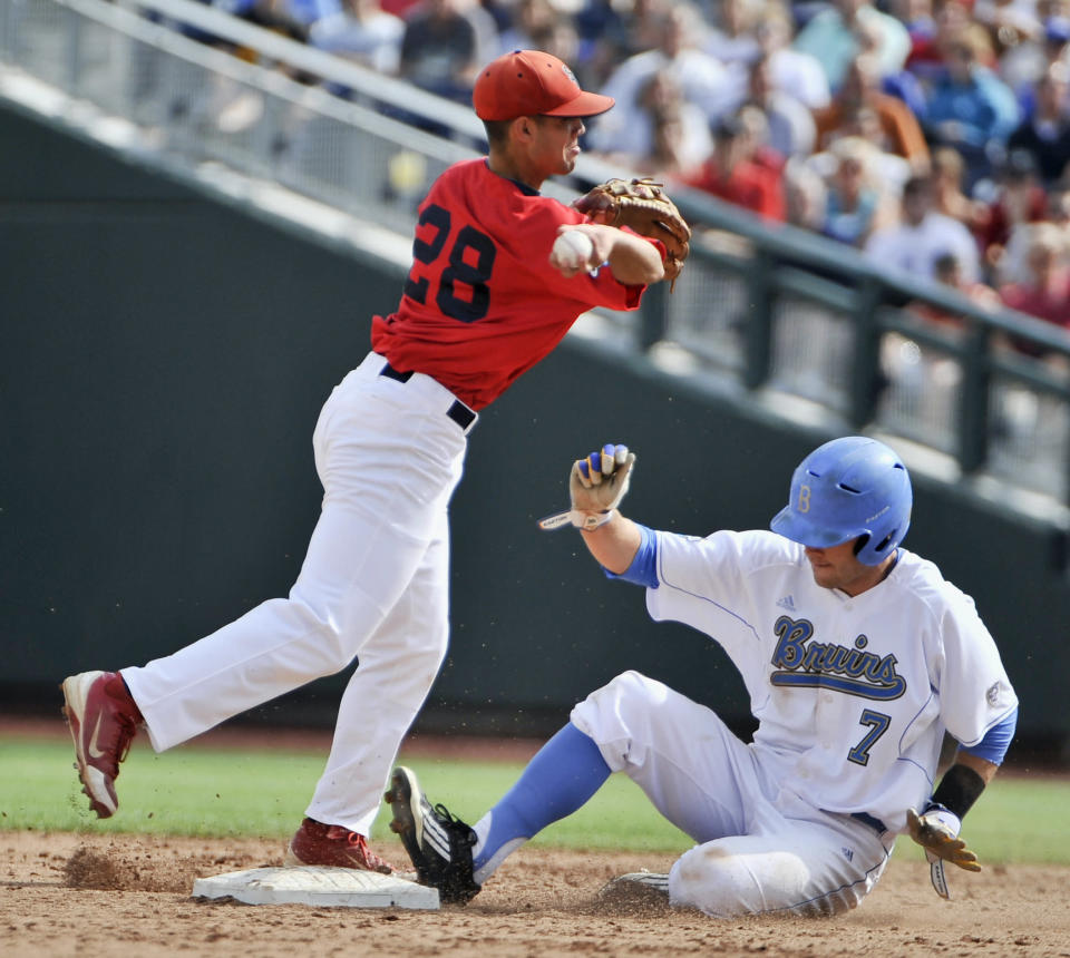 Stony Brook shortstop Cole Peragine (28) forces out UCLA's Cody Keefer on a ball hit by Jeff Gelalich, who was safe at first in the second inning of an NCAA College World Series baseball game in Omaha, Neb., Friday, June 15, 2012. (AP Photo/Eric Francis)