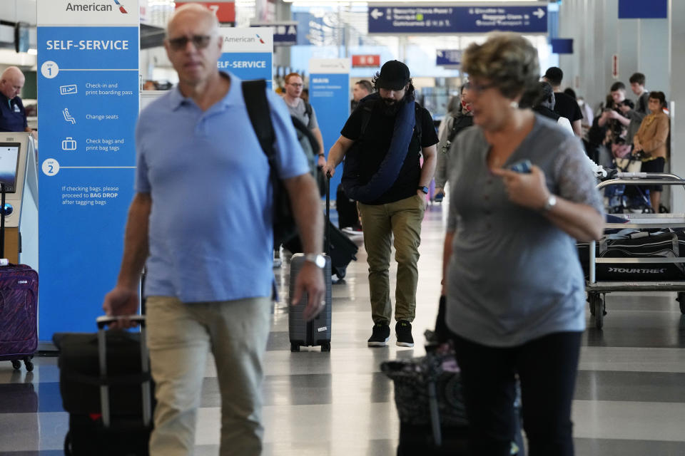 Travelers walk through Terminal 3 at O'Hare International Airport in Chicago, Thursday, Aug. 31, 2023. The Federal Aviation Administration predicts that this will be the third busiest holiday weekend of the year so far, behind only the Juneteenth weekend, which included Father's Day, and the Presidents Day break.(AP Photo/Nam Y. Huh)