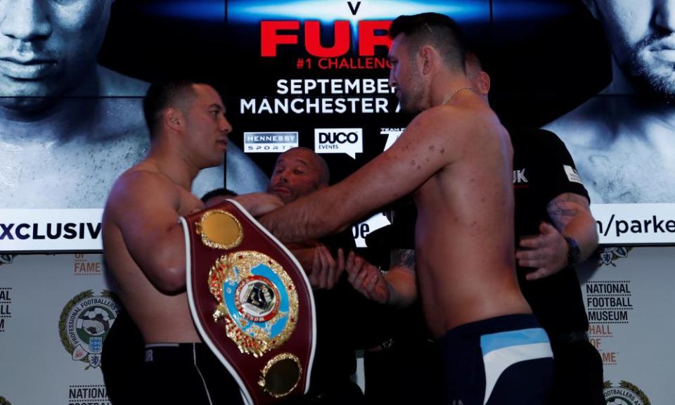 Joseph Parker, left, and Hughie Fury get in some early shoving at the weigh-in for Saturday night’s world heavyweight title fight in Manchester. 