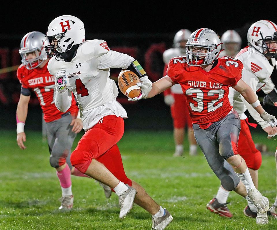 Hingham's Cameron Dobson tries to run past Silver Lake's Jake Cipullo.