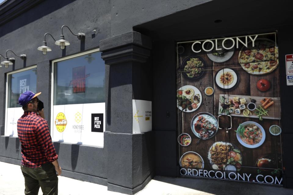 A customer looks at a sign with food choices.