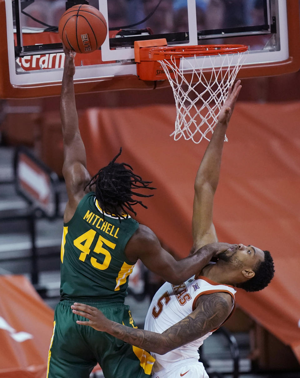 Baylor guard Davion Mitchell (45) scores over Texas forward Royce Hamm Jr. (5) during the first half of an NCAA college basketball game Tuesday, Feb. 2, 2021, in Austin, Texas. (AP Photo/Eric Gay)