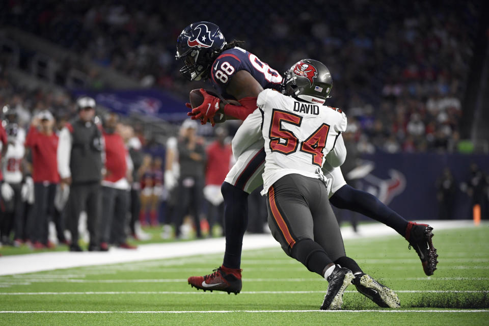 Houston Texans tight end Jordan Akins (88) is tackled by Tampa Bay Buccaneers outside linebacker Lavonte David (54) during the first half of an NFL preseason football game Saturday, Aug. 28, 2021, in Houston. (AP Photo/Justin Rex)