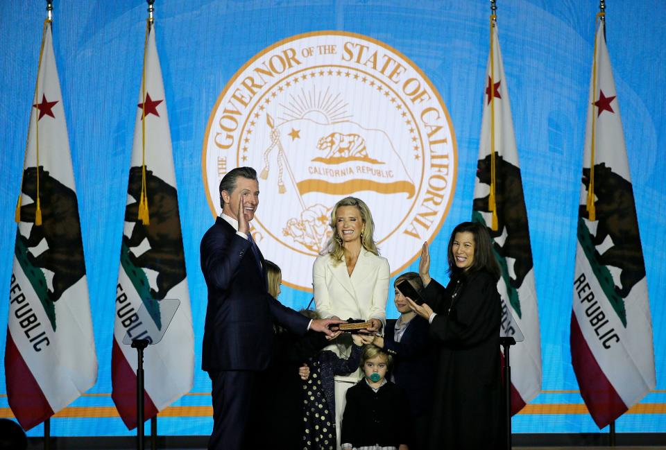 California Governor Gavin Newsom takes the oath of office from state Supreme Court Chief Justice Tani Gorre Cantil-Sakauye as his wife Jennifer Siebel Newsom and children look on during his inauguration Monday, Jan. 7, 2019, in Sacramento, Calif.