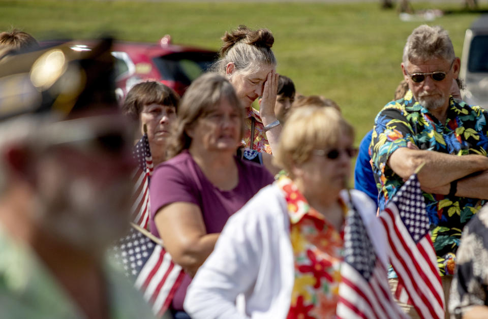 Members of the public attend a memorial service Saturday, Aug. 31, 2019, in Trumansburg, N.Y., for Sgt. James Johnston, who was killed in Afghanistan in June. Hundreds of people, some wearing Hawaiian shirts and plastic leis in Johnston's honor, lined a pathway next to bricks etched with the names of local boys who'd gone to war, some never to return. The gathering was a combination barbecue, fundraiser and day of remembrance. (AP Photo/David Goldman)