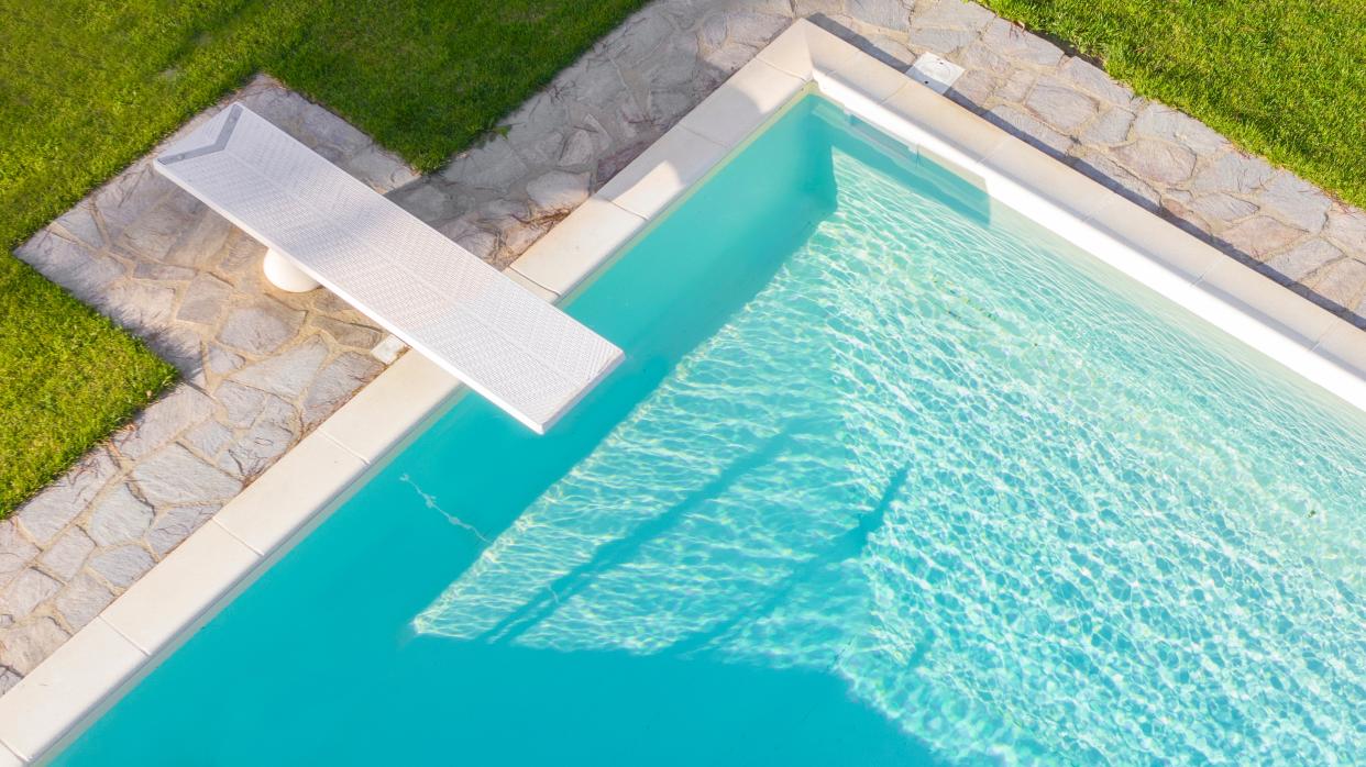  An overhead view of a clean blue swimming pool. 